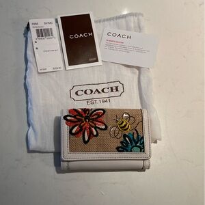 Coach small tri-fold wallet with bumble bee and flowers.